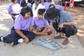 Asian teacher is teaching the music note for student group.